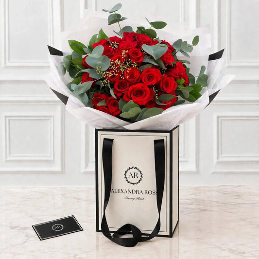 Adora red rose bouquet with eucalyptus, available half dozen to two dozen.