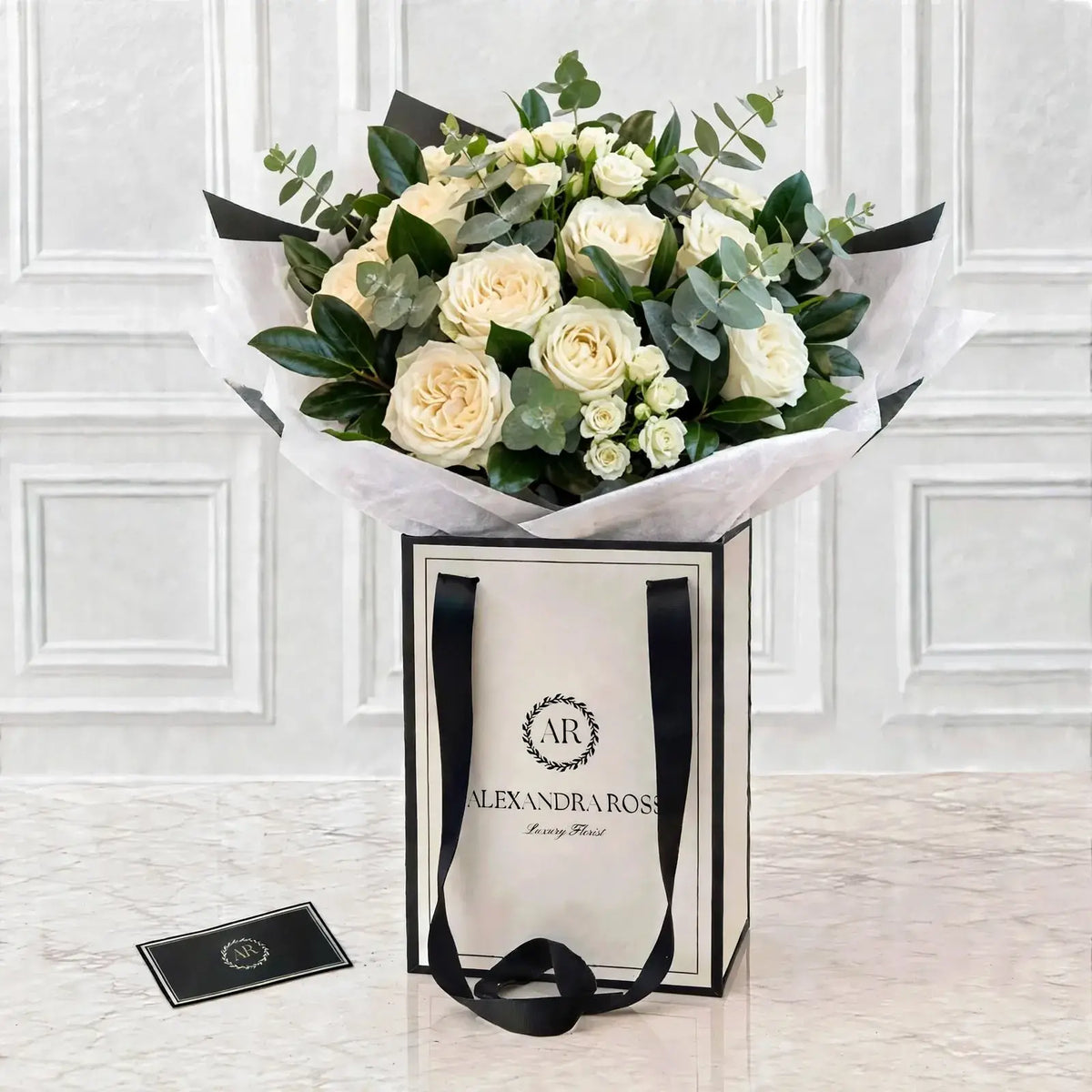 Elegant white garden roses paired with fragrant eucalyptus in this fuller, chalice-bloom bouquet. Handmade fresh, delivered UK-wide from £4.95.