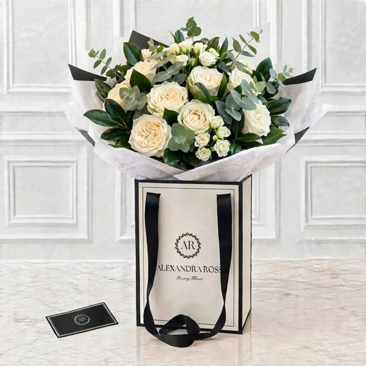 Elegant white garden roses paired with fragrant eucalyptus in this fuller, chalice-bloom bouquet. Handmade fresh, delivered UK-wide from £4.95.