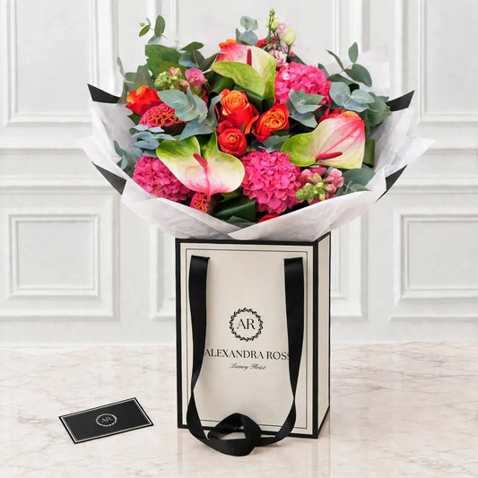 Eve luxury bouquet — hot pink and orange arrangement with hydrangea, two-tone anthuriums and Cherry Brandy roses