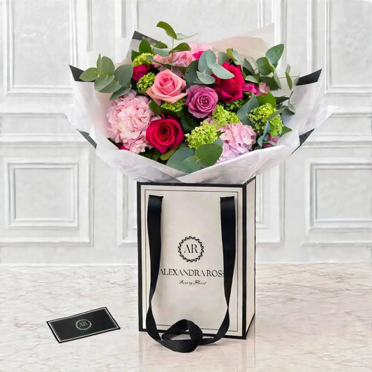 Three shades of pink roses with pale pink hydrangea, apple-green Guelder rose and eucalyptus — a balanced, romantic bouquet. UK nationwide delivery.